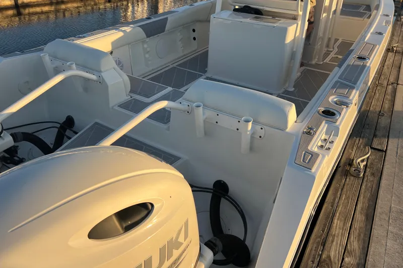 Slide: The Image of 1997 Sea Cat SL5 Cat boat interior with Suzuki engine, docked at sunset. - 18