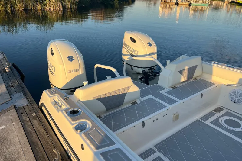 Slide: The Image of 1997 Sea Cat SL5 Cat boat with twin Suzuki 200 engines docked by calm water. - 20