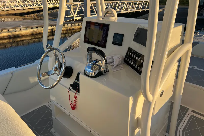 Slide: The Image of 1997 Sea Cat SL5 Cat boat console with steering wheel and navigation controls. - 22