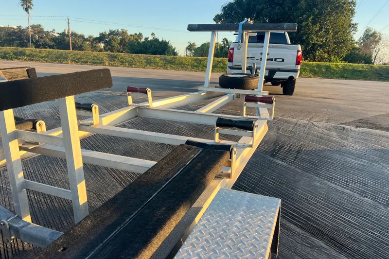 Slide: The Image of Boat trailer for 1997 Sea Cat SL5 Cat, parked near a white truck. - 27