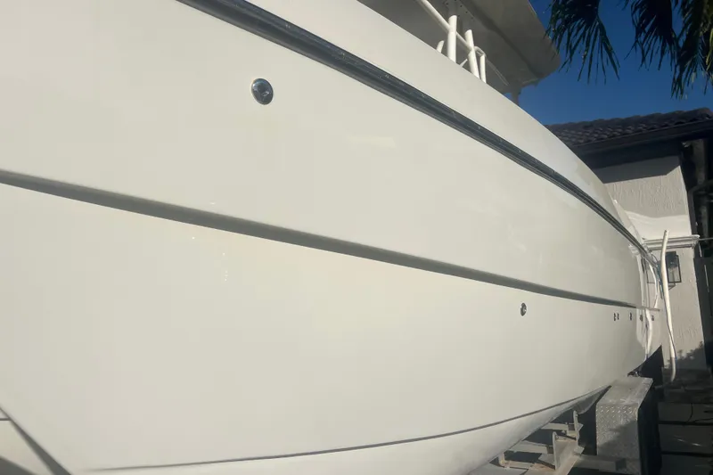 Slide: The Image of 1997 Sea Cat SL5 Cat boat side view, showcasing sleek white hull design. - 35