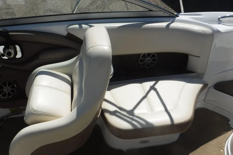 Slide: The Image of Interior of 2010 Cobalt 242 boat with white leather seating and speaker system. - 11