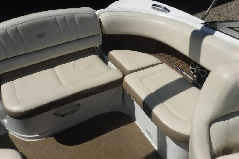 Slide: The Image of 2010 Cobalt 242 boat interior with beige and brown cushioned seating. - 12