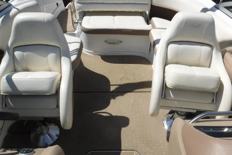 Slide: The Image of Interior of a 2010 Cobalt 242 boat with white leather seating. - 13