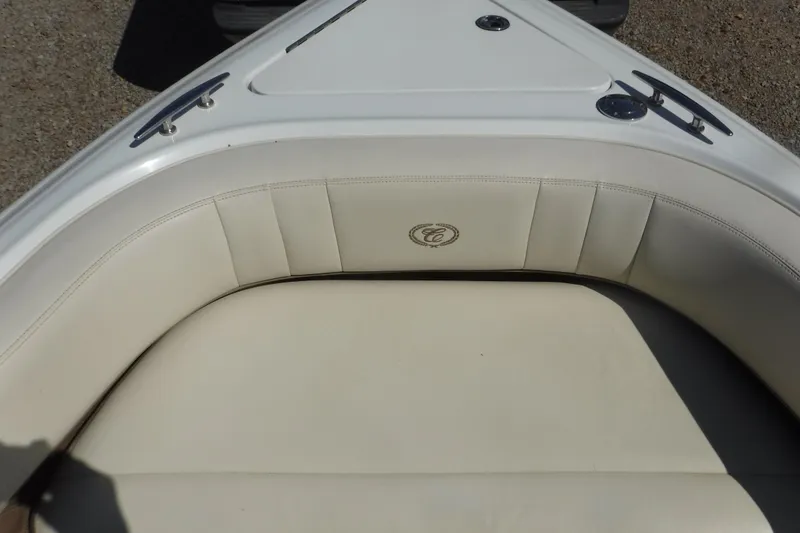 Slide: The Image of 2010 Cobalt 242 boat with beige cushioned seating and sleek design. - 14
