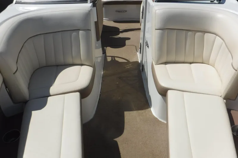 Slide: The Image of 2010 Cobalt 242 boat interior with white leather seating and beige carpet. - 15