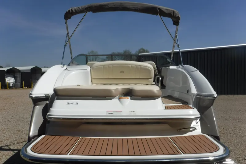 Slide: The Image of 2010 Cobalt 242 boat with beige seating and teak swim platform. - 19
