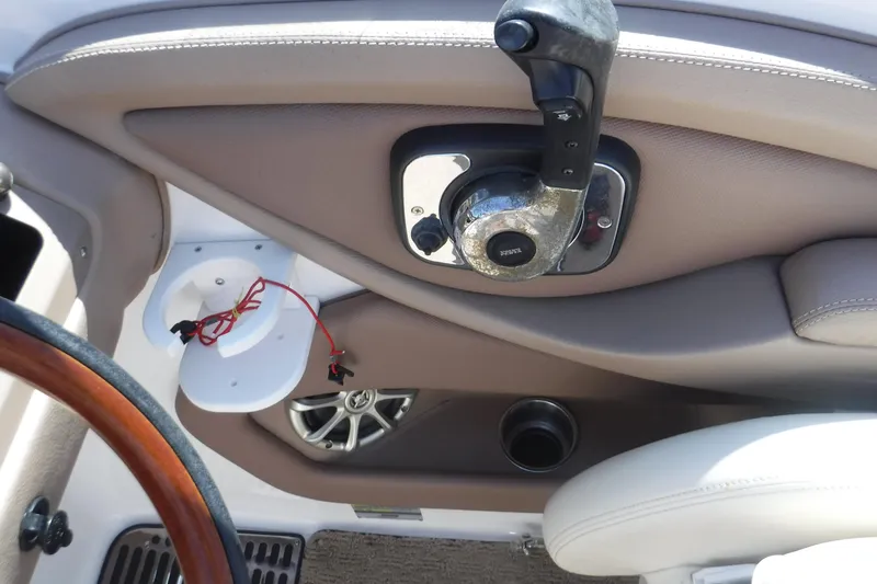 Slide: The Image of Interior of 2010 Cobalt 242 boat showing throttle control and speaker. - 3