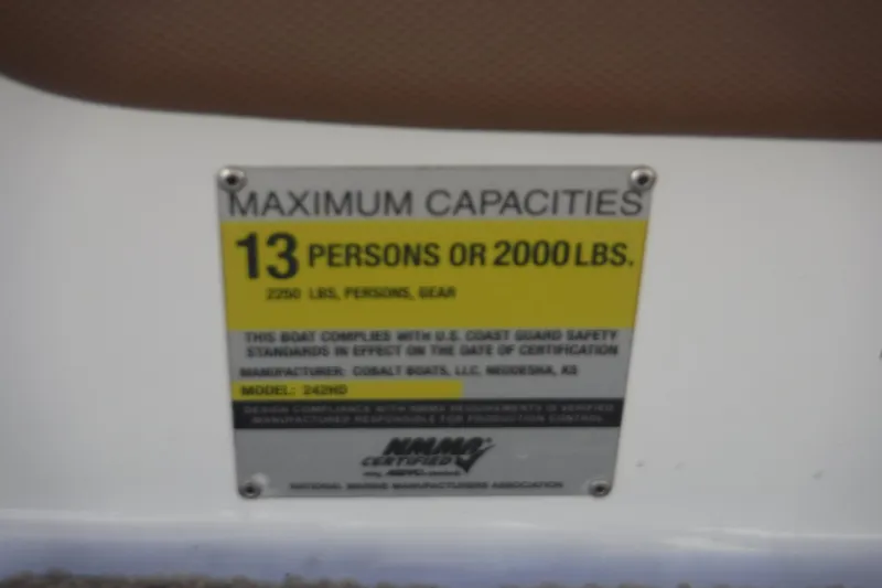 Slide: The Image of 2010 Cobalt 242 capacity plate: 13 persons or 2000 lbs, US Coast Guard compliant. - 4