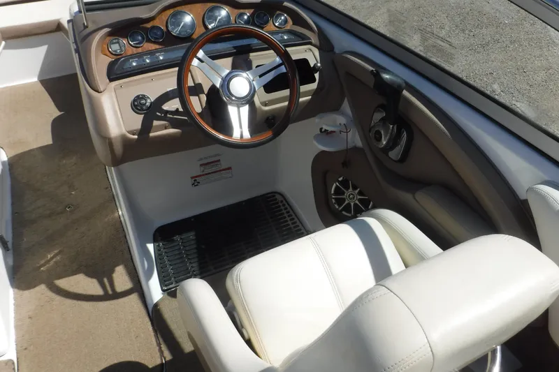 Slide: The Image of 2010 Cobalt 242 boat interior with steering wheel and dashboard controls. - 6