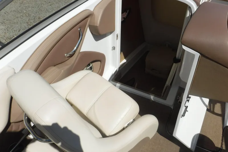 Slide: The Image of Interior of a 2010 Cobalt 242 boat, featuring beige and brown seating. - 8
