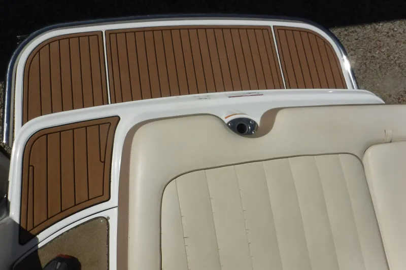 Slide: The Image of 2010 Cobalt 242 boat with beige seating and brown deck flooring. - 9