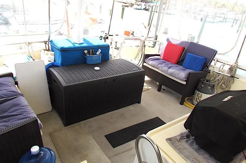 Slide: The Image of 1992 Hatteras 40 Motor Yacht interior with seating, storage, and colorful cushions. - 11