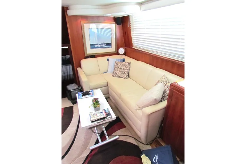 Slide: The Image of Interior of 1992 Hatteras 40 Motor Yacht with cozy seating and nautical decor. - 12