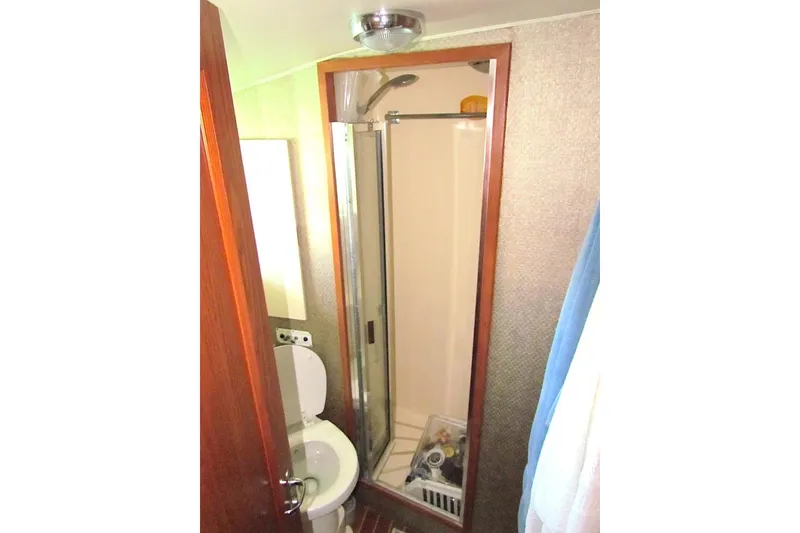 Slide: The Image of Bathroom interior of 1992 Hatteras 40 Motor Yacht with shower and toilet. - 13