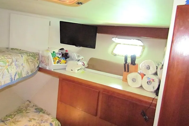 Slide: The Image of Interior of 1992 Hatteras 40 Motor Yacht with bunk beds and storage. - 14