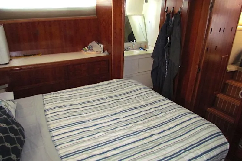 Slide: The Image of Interior cabin of 1992 Hatteras 40 Motor Yacht with bed and wooden furnishings. - 19