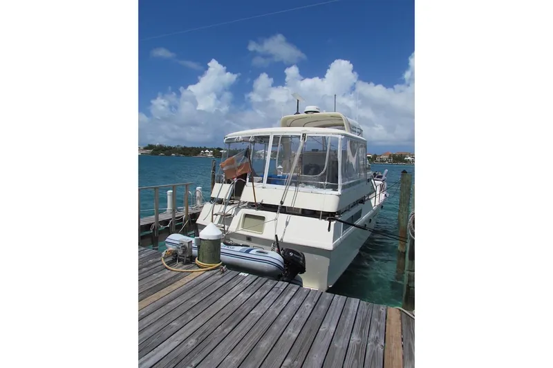 Slide: The Image of 1992 Hatteras 40 Motor Yacht docked on a sunny day with clear skies. - 2