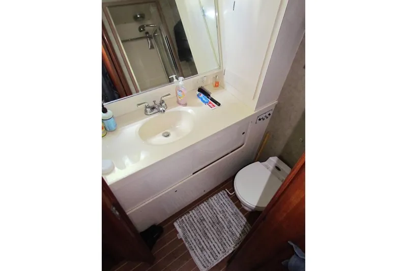 Slide: The Image of Bathroom interior of 1992 Hatteras 40 Motor Yacht with sink, mirror, and toilet. - 21