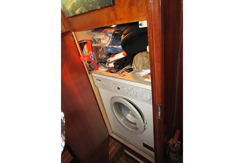Slide: The Image of Laundry area with storage in 1992 Hatteras 40 Motor Yacht. - 23