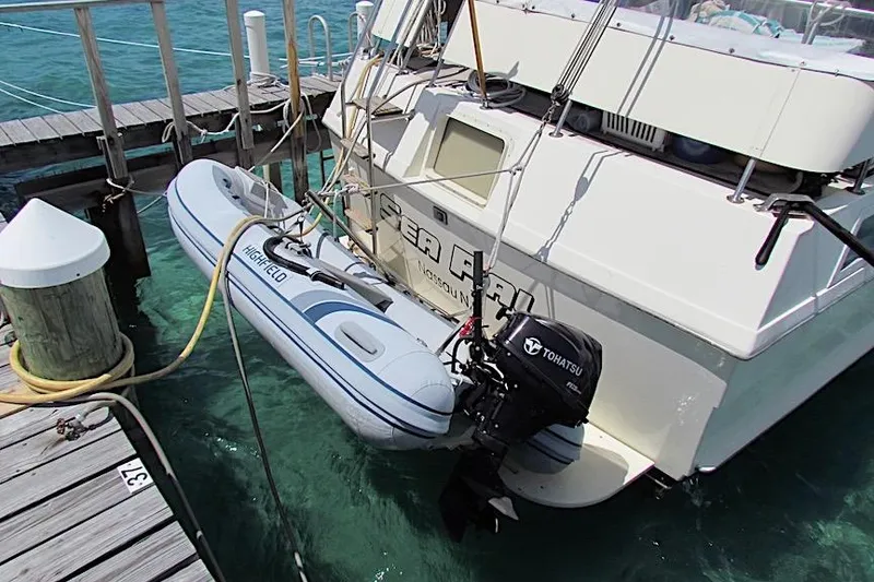 Slide: The Image of 1992 Hatteras 40 Motor Yacht docked with inflatable boat and Tohatsu motor. - 3