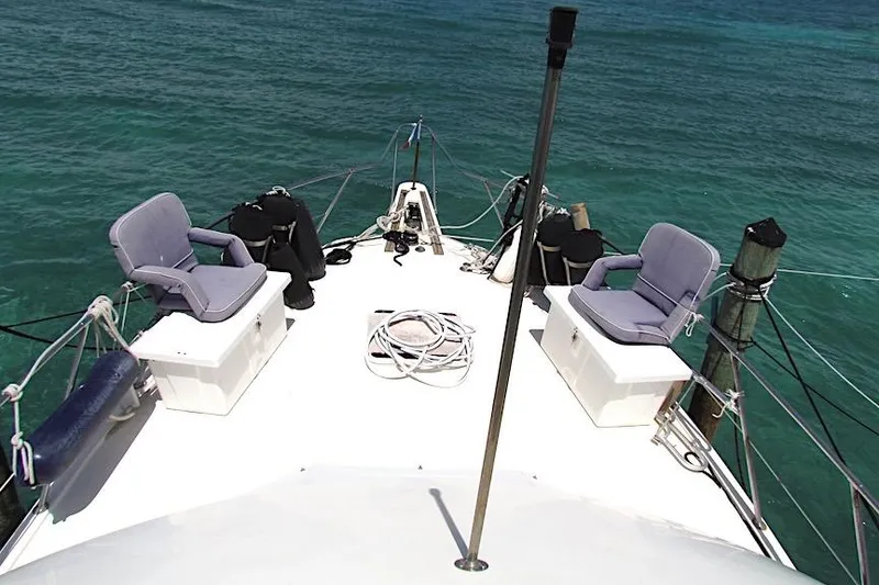 Slide: The Image of 1992 Hatteras 40 Motor Yacht deck with seating, overlooking clear blue water. - 4