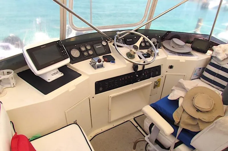 Slide: The Image of 1992 Hatteras 40 Motor Yacht helm with navigation equipment and steering wheel. - 8