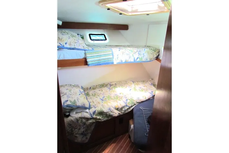 Slide: The Image of Interior of 1992 Hatteras 40 Motor Yacht with bunk beds and floral bedding. - 9