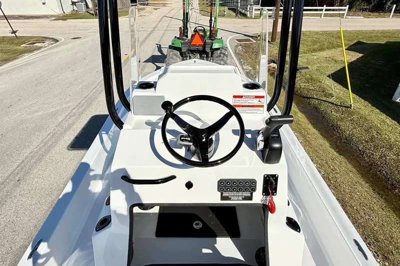 Slide: The Image of 2026 Shallow Sport 24 Sport boat console with steering wheel and controls. - 10