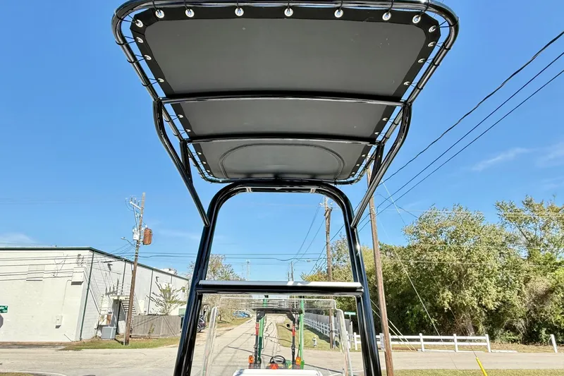 Slide: The Image of 2026 Shallow Sport 24 Sport boat T-top against blue sky background. - 11