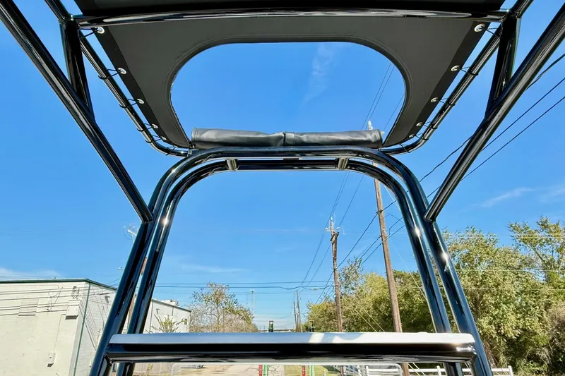 Slide: The Image of 2026 Shallow Sport 24 Sport boat tower against clear blue sky. - 12