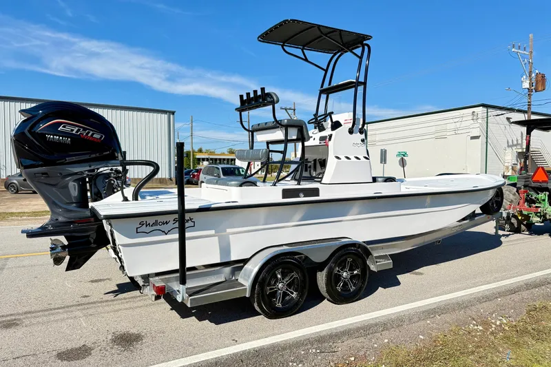 Slide: The Image of 2026 Shallow Sport 24 Sport boat on trailer, featuring Yamaha engine, parked outdoors. - 4