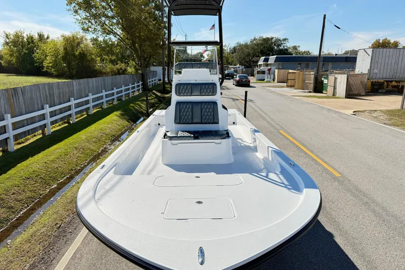 Slide: The Image of 2026 Shallow Sport 24 Sport boat on a sunny street, showcasing sleek design. - 6