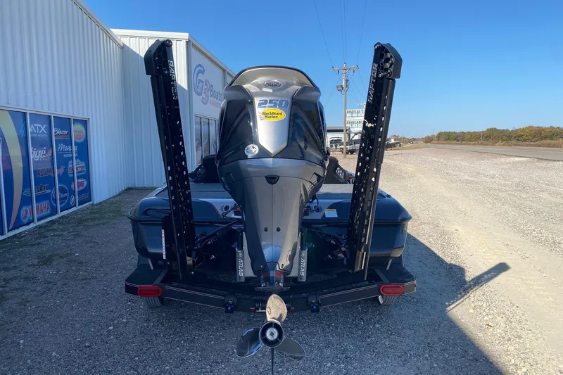Slide: The Image of 2026 Skeeter ZXE20 boat with powerful outboard motor, parked near a dealership. - 6