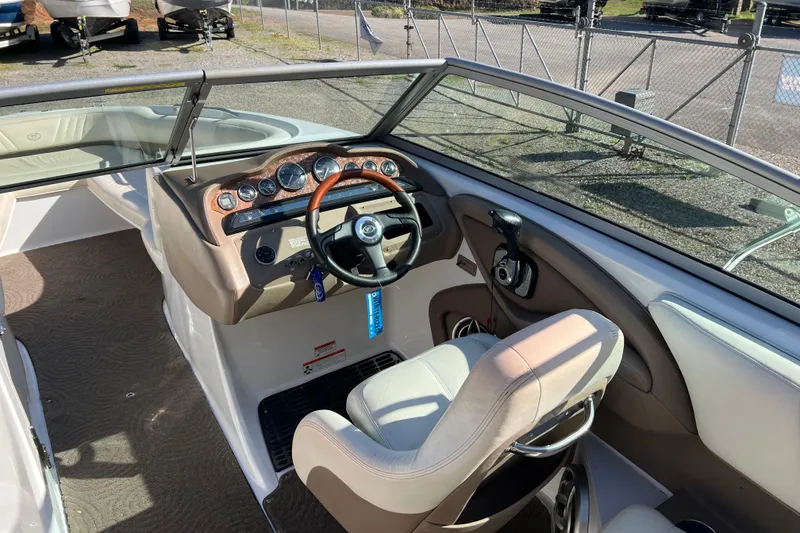 Slide: The Image of 2008 Cobalt 252 boat interior with steering wheel and dashboard controls. - 11