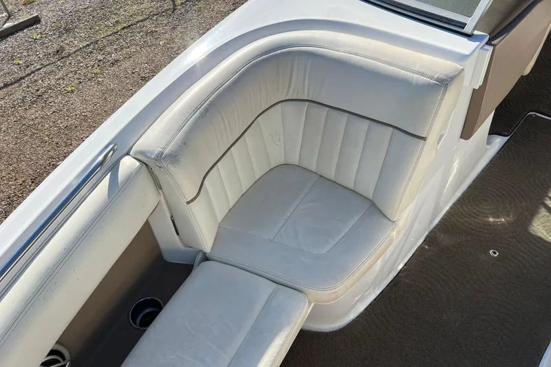 Slide: The Image of 2008 Cobalt 252 boat interior with white leather seating and cup holders. - 15