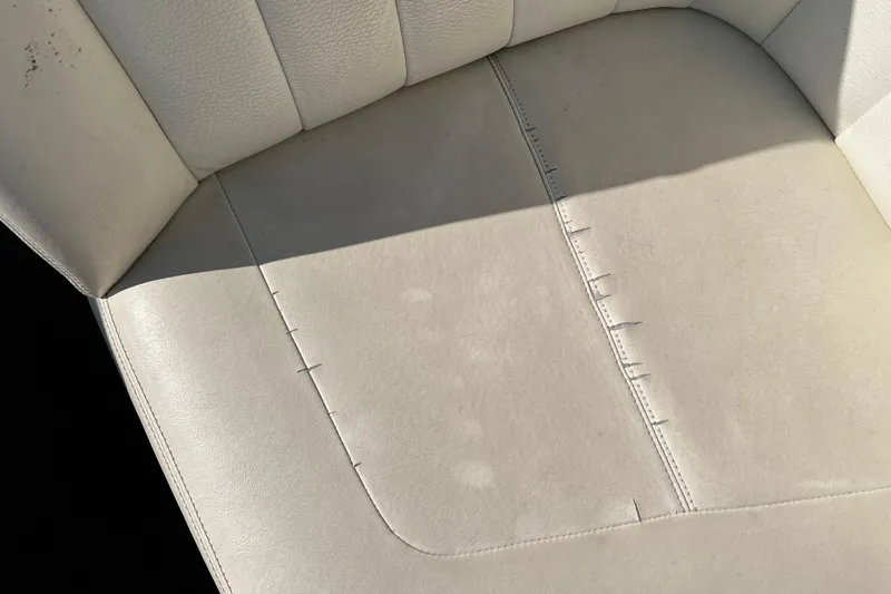 Slide: The Image of 2008 Cobalt 252 boat seat with visible wear and stitching details. - 16