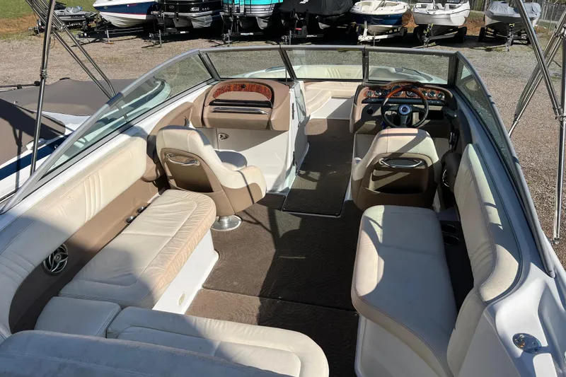Slide: The Image of Interior of a 2008 Cobalt 252 boat with beige seating and steering wheel. - 7