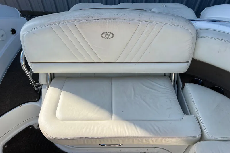 Slide: The Image of White leather seating on a 2008 Cobalt 252 boat, featuring elegant stitching and logo. - 8