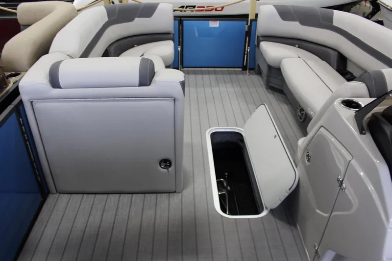 Slide: The Image of 2025 Sylvan L5 CLZ DH boat interior with gray seating and open storage compartment. - 16