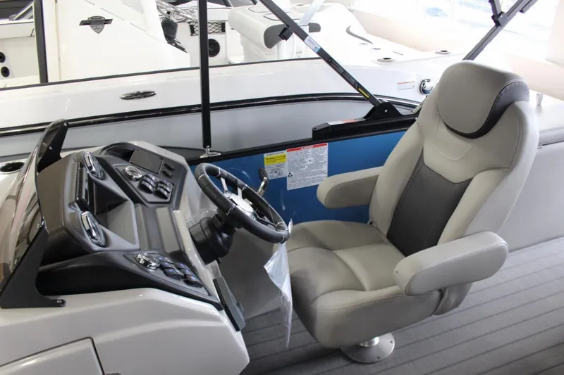 Slide: The Image of 2025 Sylvan L5 CLZ DH boat interior with steering wheel and captain's chair. - 8