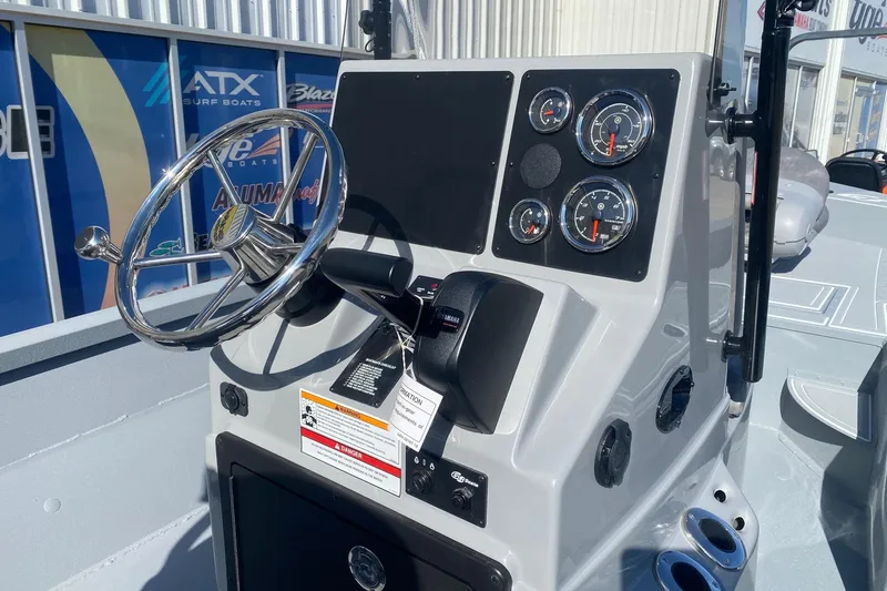 Slide: The Image of 2026 G3 Bay 19 GX boat dashboard with steering wheel and gauges. - 15