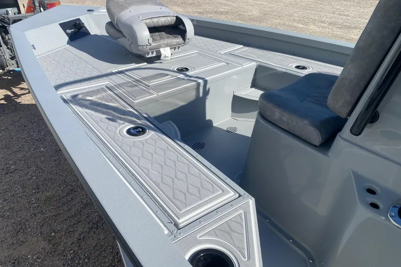 Slide: The Image of 2026 G3 Bay 19 GX boat interior with gray seating and storage compartments. - 18