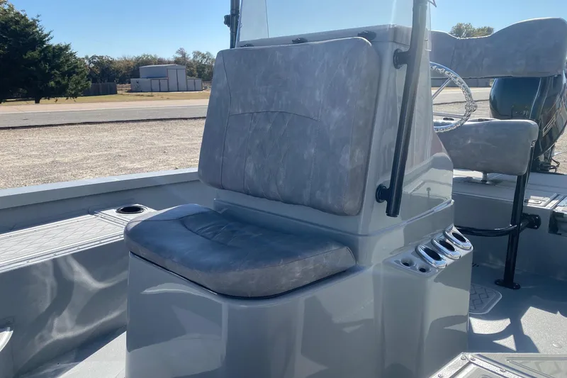 Slide: The Image of 2026 G3 Bay 19 GX boat interior with cushioned seating and steering console. - 19