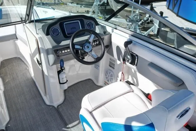 Slide: The Image of 2019 Chaparral 21 H2O Surf boat interior with steering wheel and control panel. - 13