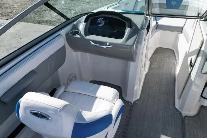 Slide: The Image of 2019 Chaparral 21 H2O Surf boat interior with steering console and seating. - 14