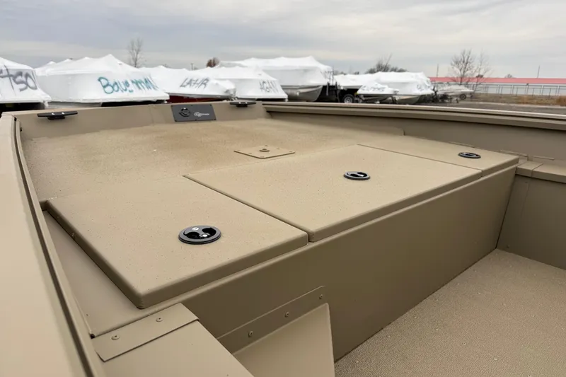 Slide: The Image of 2026 G3 Gator Tough 17 SC boat deck with storage compartments, outdoors. - 11