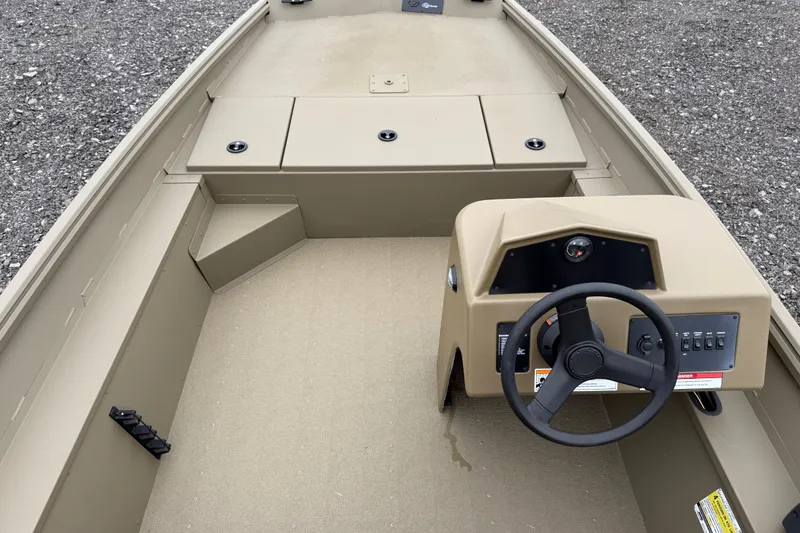 Slide: The Image of 2026 G3 Gator Tough 17 SC boat interior with steering console and storage compartments. - 13