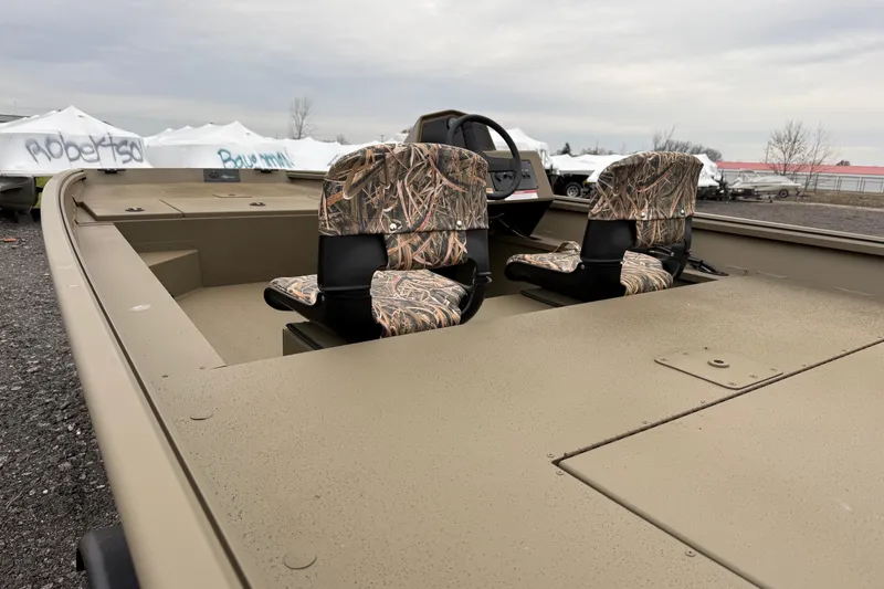 Slide: The Image of 2026 G3 Gator Tough 17 SC boat with camo seats, parked outdoors. - 8