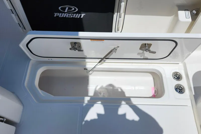 Slide: The Image of 2026 Pursuit S 328 Sport boat with luxurious gray seating and quilted design. - 11